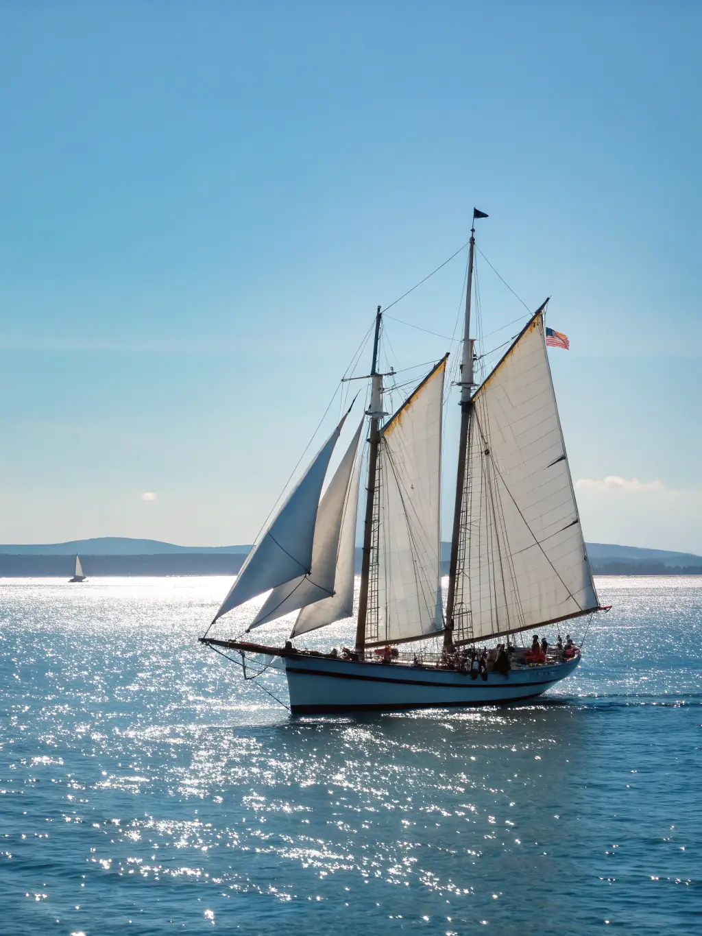 A classic sailboat gently gliding on the calm waters of Biscayne Bay, offering a serene and picturesque sailing experience.